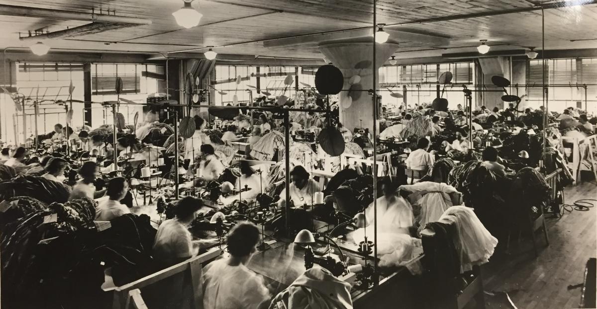 Photograph of the floor of the Nelly Don factory, showing well-lit working conditions