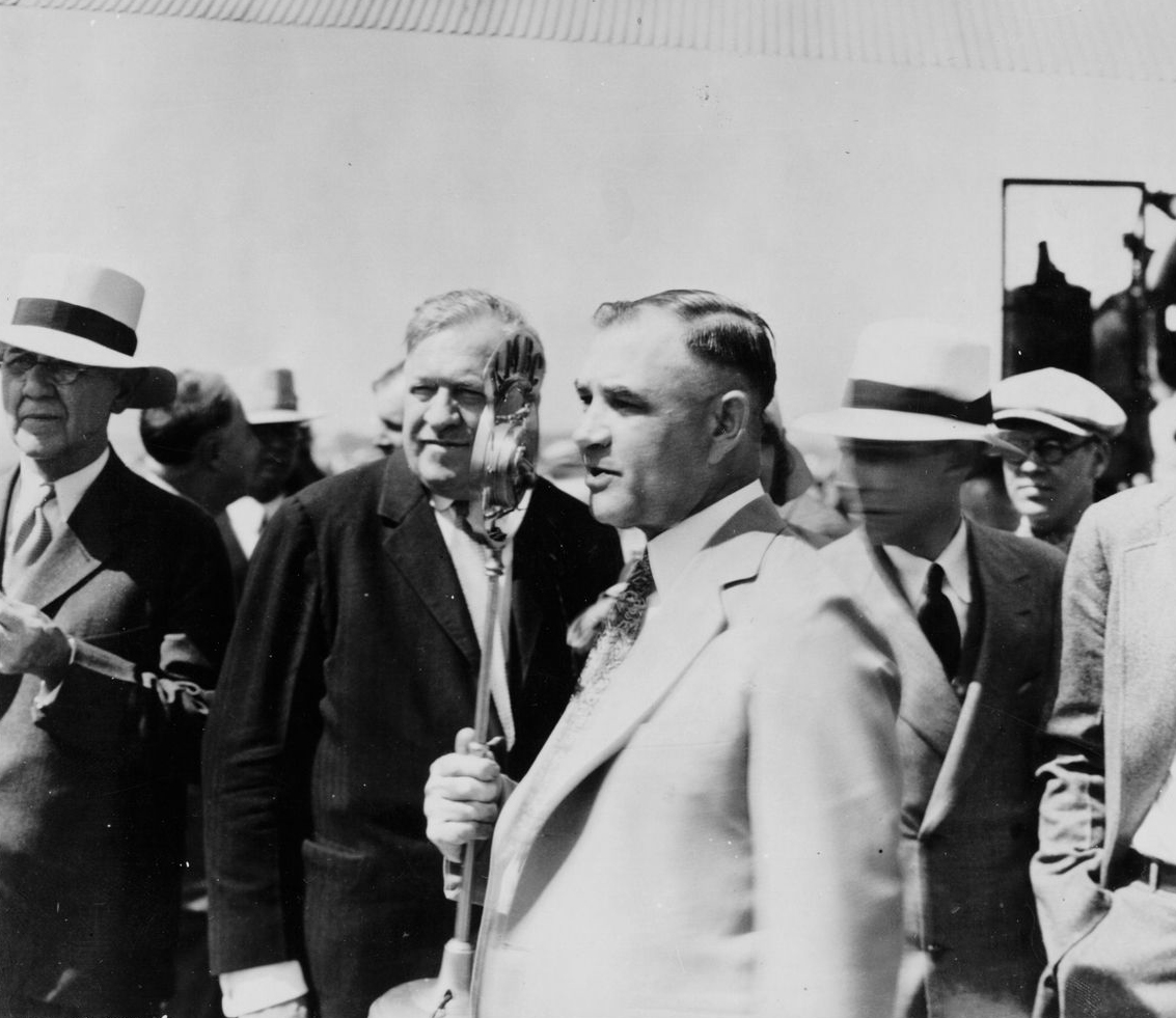 Lou Holland, Conrad Mann and other unidentified people at airport dedication.